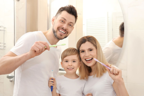 Happy family brushing their teeth